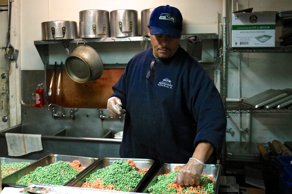 Greg telling me his story as he preps meals